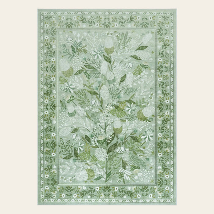 Covaba modern botanical floral area rug in sage mist, shown flat on a plain ivory backdrop