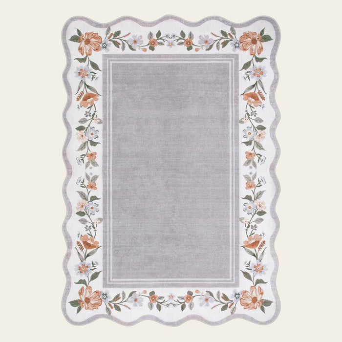 Covaba vintage floral scalloped doormat in muted plum, shown flat on a plain ivory backdrop