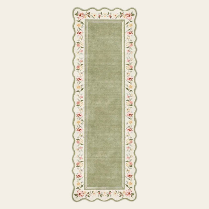 Covaba vintage floral scalloped runner rug in willow sage, shown flat on a plain ivory backdrop