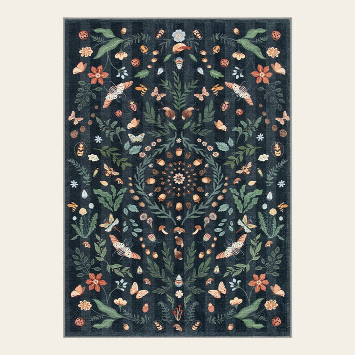 Covaba boho insect botanical floral doormat in ink black, shown flat on a plain ivory backdrop
