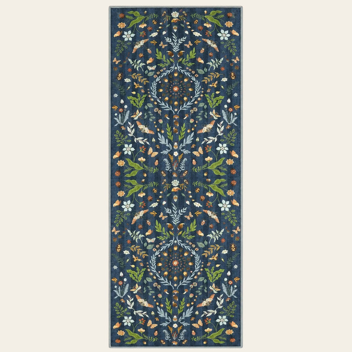 Covaba boho insect botanical floral runner rug in stormy blue, shown flat on a plain ivory backdrop