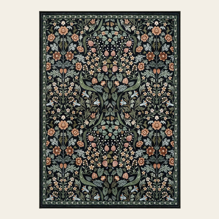 Covaba maximalism vibrant blossom floral area rug in ink black, shown flat on a plain ivory backdrop