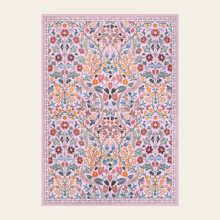 Covaba maximalism vibrant blossom floral area rug in blush clay, shown flat on a plain ivory backdrop