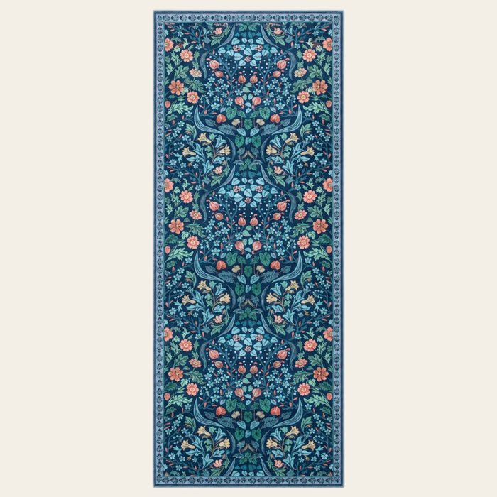 Covaba maximalism vibrant floral runner rug in stormy blue, shown flat on a plain ivory backdrop