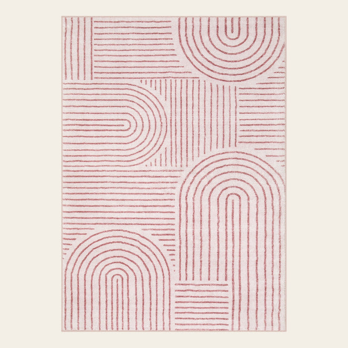 Covaba abstract rainbow stripe pink/white area rug in blush clay, shown flat on a plain ivory backdrop