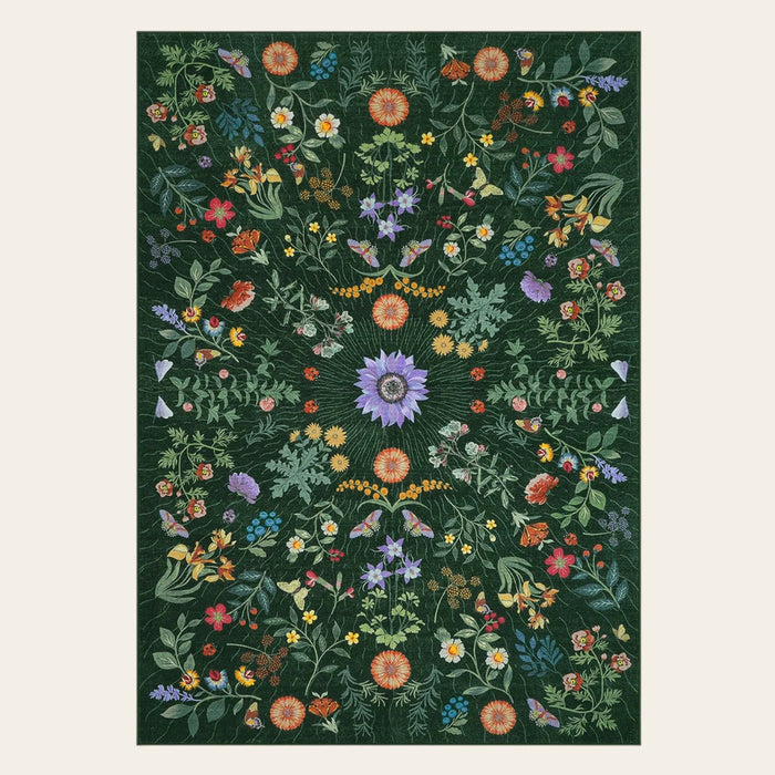 Covaba boho botanical floral area rug in fern green, shown flat on a plain ivory backdrop