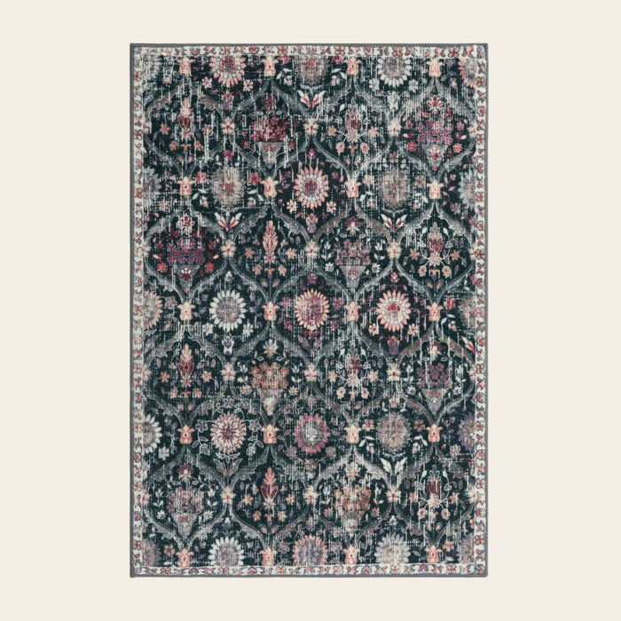 Covaba ultra-thin vintage floral moroccan trellis doormat in ink black, shown flat on a plain ivory backdrop