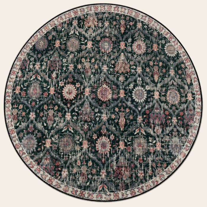 Covaba ultra-thin vintage floral moroccan trellis round rug in ink black, shown flat on a plain ivory backdrop
