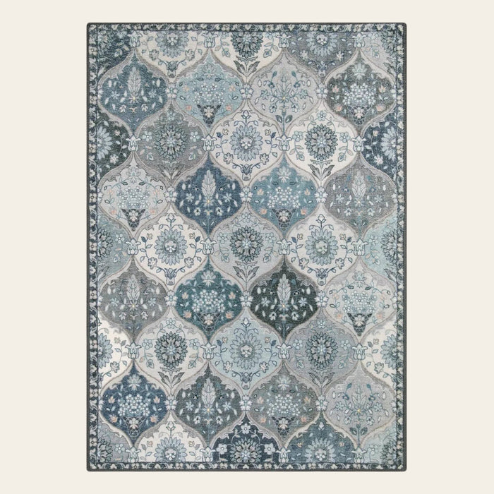 Covaba ultra-thin vintage floral moroccan trellis doormat in stormy blue, shown flat on a plain ivory backdrop