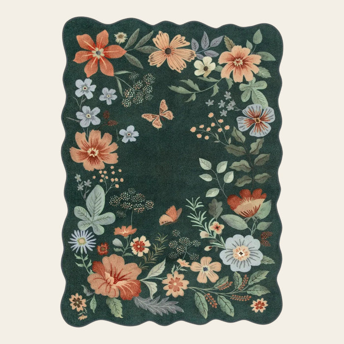 Covaba boho modern parisian floral scalloped area rug in forest fern, shown flat on a plain ivory backdrop