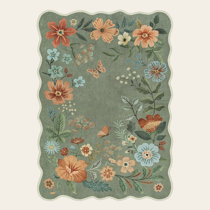 Covaba boho modern parisian floral scalloped area rug in fern green, shown flat on a plain ivory backdrop
