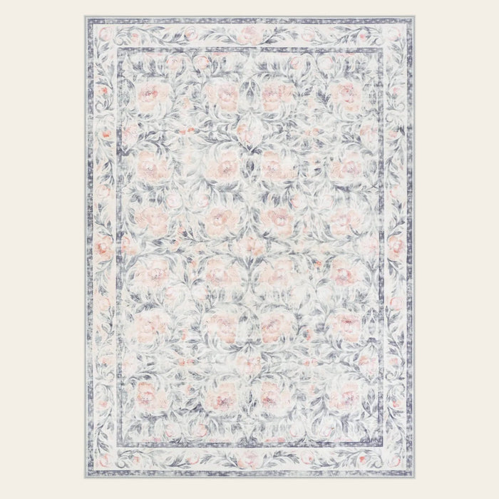 Covaba vintage floral area rug in muted plum, shown flat on a plain ivory backdrop