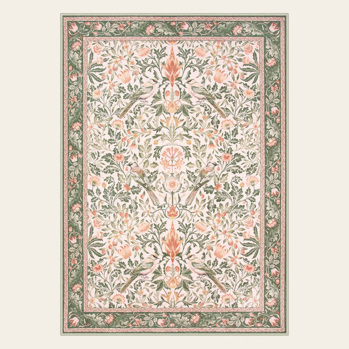 Covaba vintage floral bird area rug in blush clay, shown flat on a plain ivory backdrop