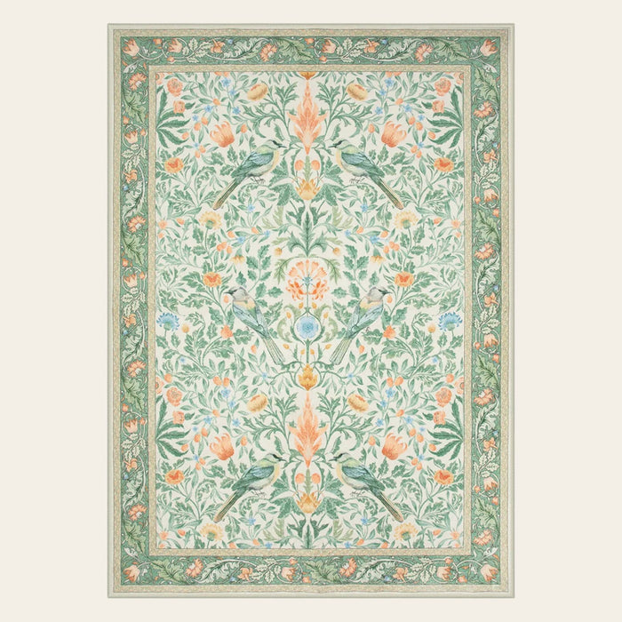 Covaba vintage floral bird area rug in willow sage, shown flat on a plain ivory backdrop