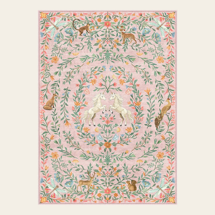 Covaba fantasy garden and unicorn area rug in blush clay, shown flat on a plain ivory backdrop