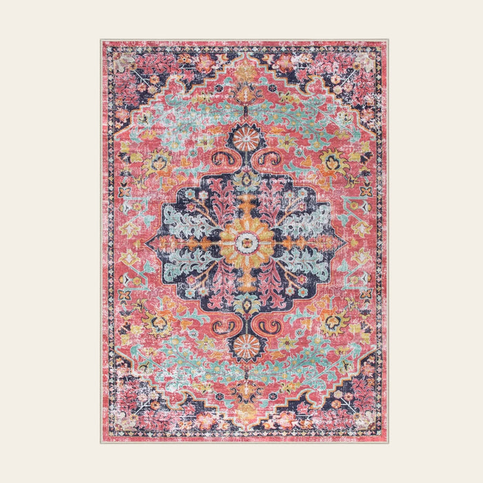 Covaba bohemian floral medallion area rug in faded rose, shown flat on a plain ivory backdrop