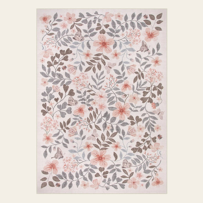Covaba vintage botanical floral area rug in warm beige, shown flat on a plain ivory backdrop