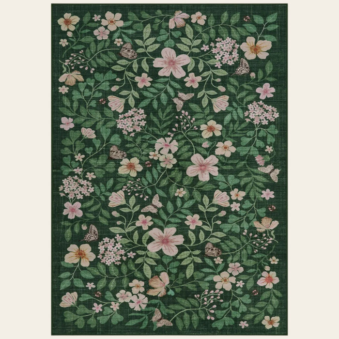 Covaba vintage botanical floral area rug in fern green, shown flat on a plain ivory backdrop