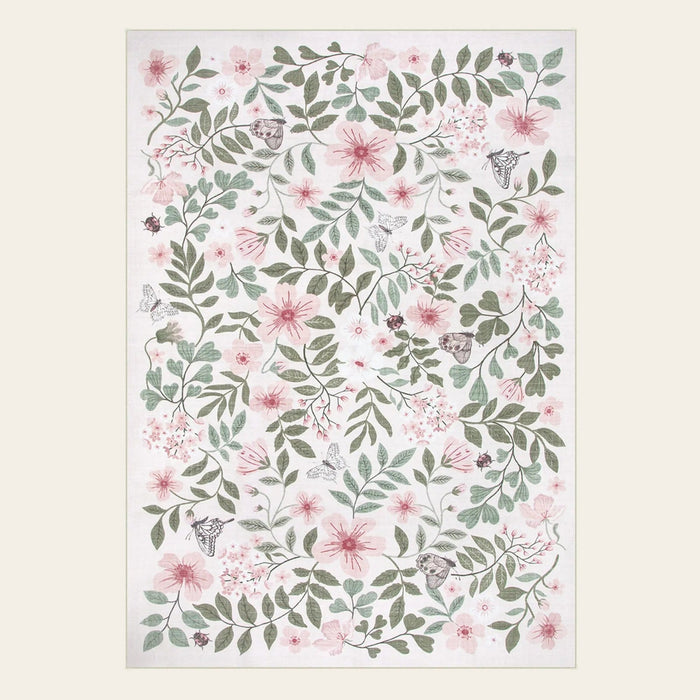 Covaba vintage botanical floral area rug in blush clay, shown flat on a plain ivory backdrop