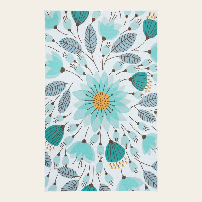 Covaba floral indoor outdoor area rug in stormy blue, shown flat on a plain ivory backdrop