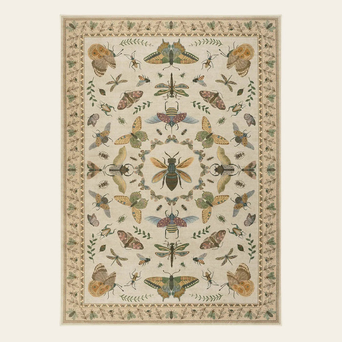 Covaba cottagecore botanical insect area rug in warm beige, shown flat on a plain ivory backdrop