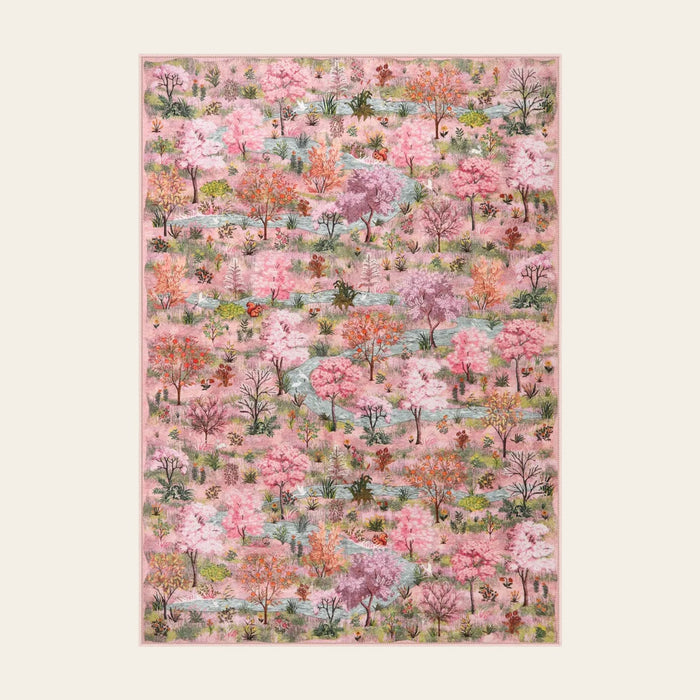 Covaba forest woodland area rug in blush clay, shown flat on a plain ivory backdrop