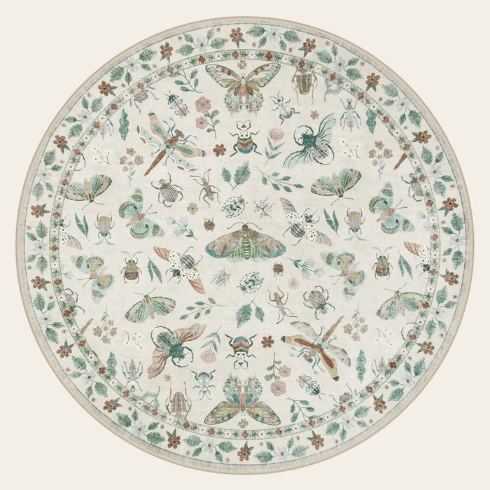 Covaba modern parisian insect round rug in warm beige, shown flat on a plain ivory backdrop