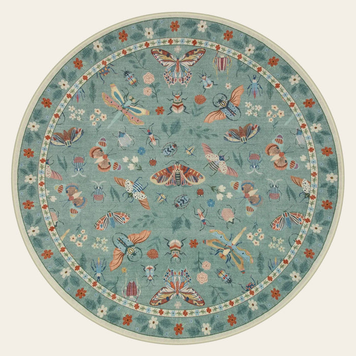 Covaba modern parisian insect round rug in sage mist, shown flat on a plain ivory backdrop