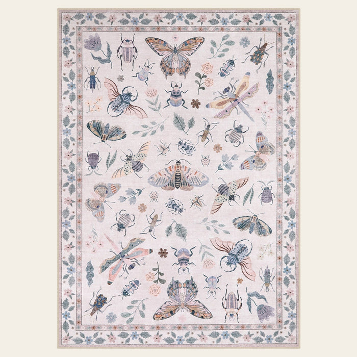 Covaba modern parisian insect area rug in soft blush, shown flat on a plain ivory backdrop