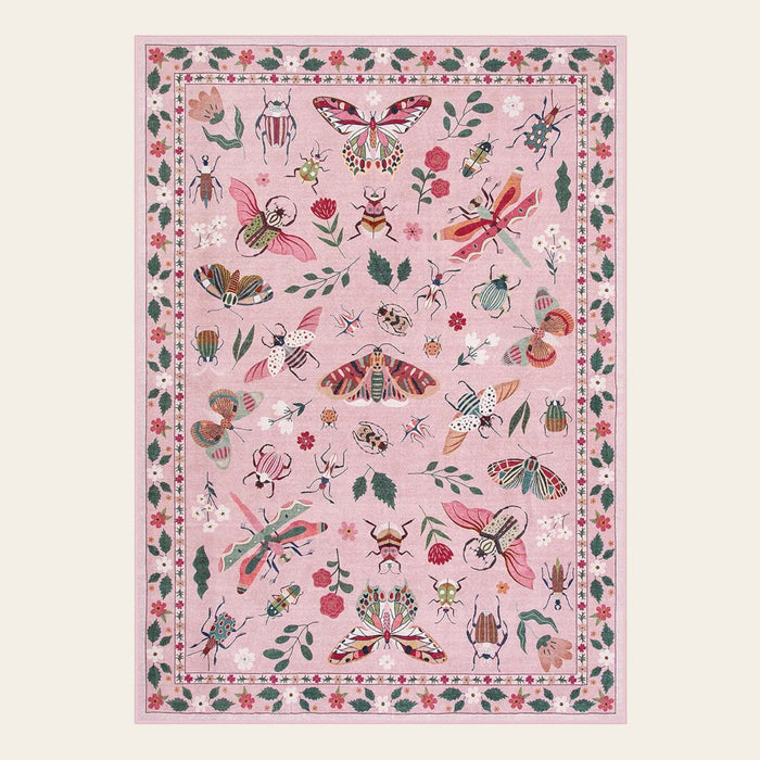 Covaba modern parisian insect area rug in blush clay, shown flat on a plain ivory backdrop