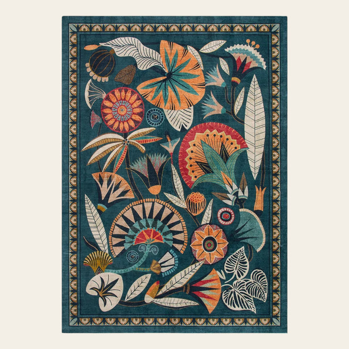 Covaba egyptian-inspired botanical area rug in teal haze, shown flat on a plain ivory backdrop