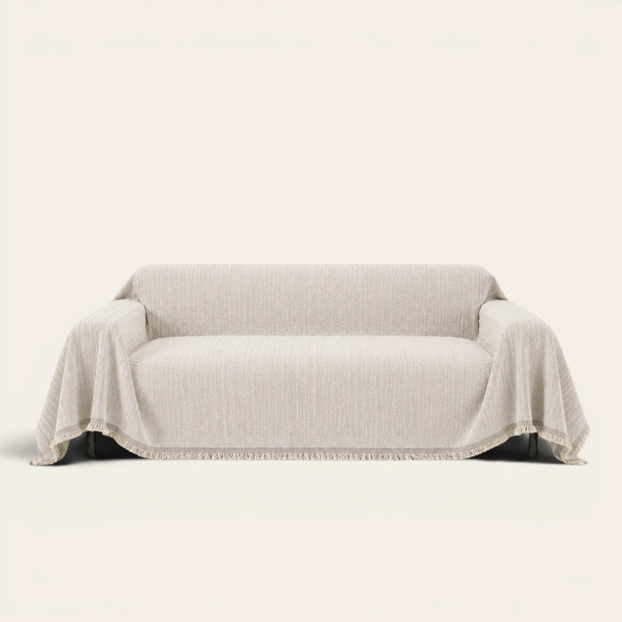 Oat Beige Linen Knit sofa throw on a plain studio background