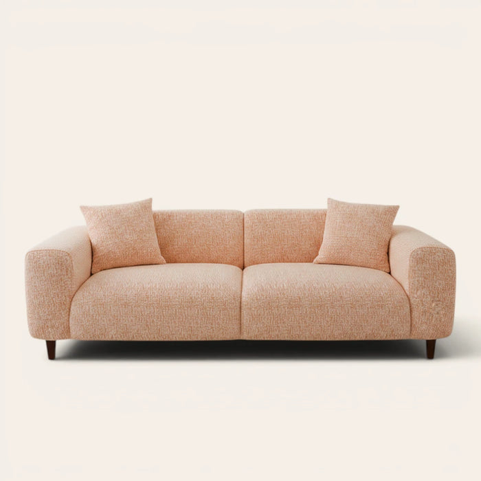 Peach clay chenille stretch cover fitted on a plush three-seat sofa, front view on ivory backdrop