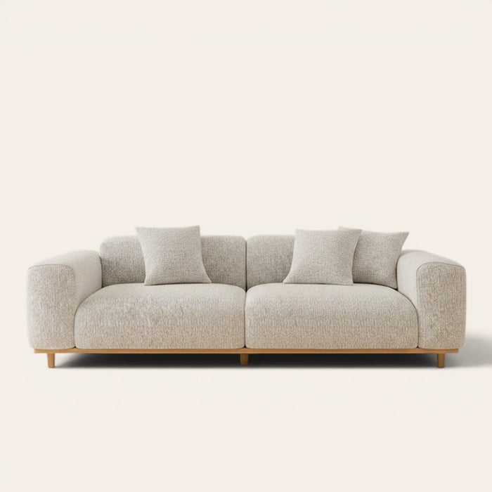 Sage veil chenille stretch cover fitted on a plush three-seat sofa with wooden base, front view