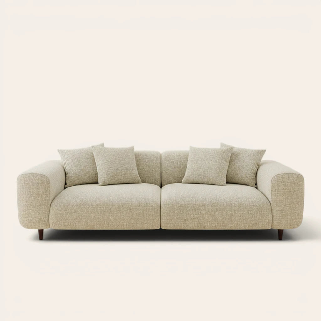 Sage veil chenille stretch cover fitted on a plush three-seat sofa, front view on ivory backdrop