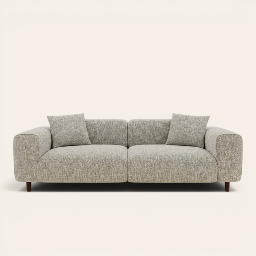 Stone mist chenille stretch cover fitted on a plush three-seat sofa, front view on ivory backdrop