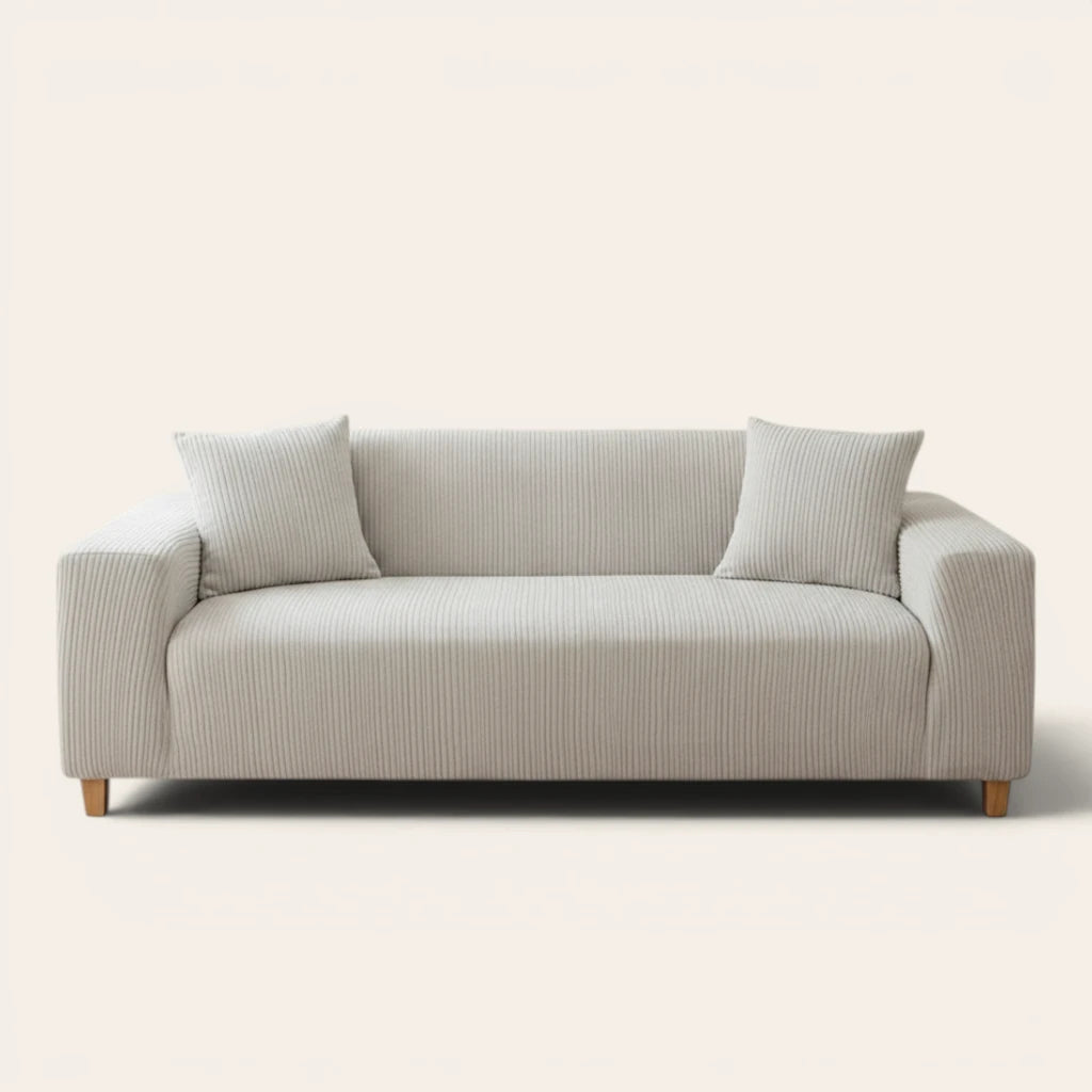 Silver Cloud corduroy sofa cover fitted on a three-seat sofa with matching cushions, front view on ivory