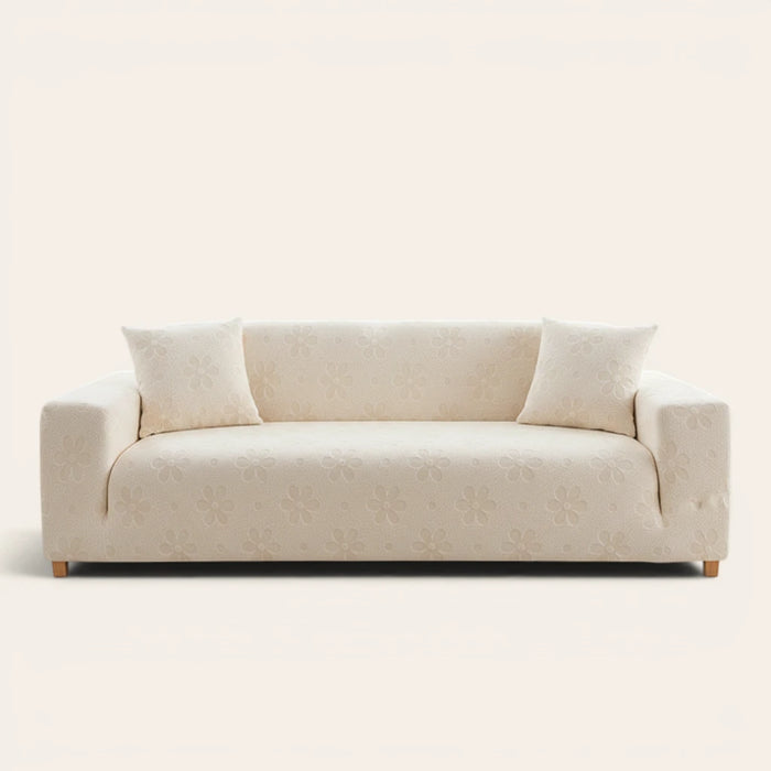 Cream Petal floral sofa cover fitted on a three-seat sofa with matching cushions, front view on ivory