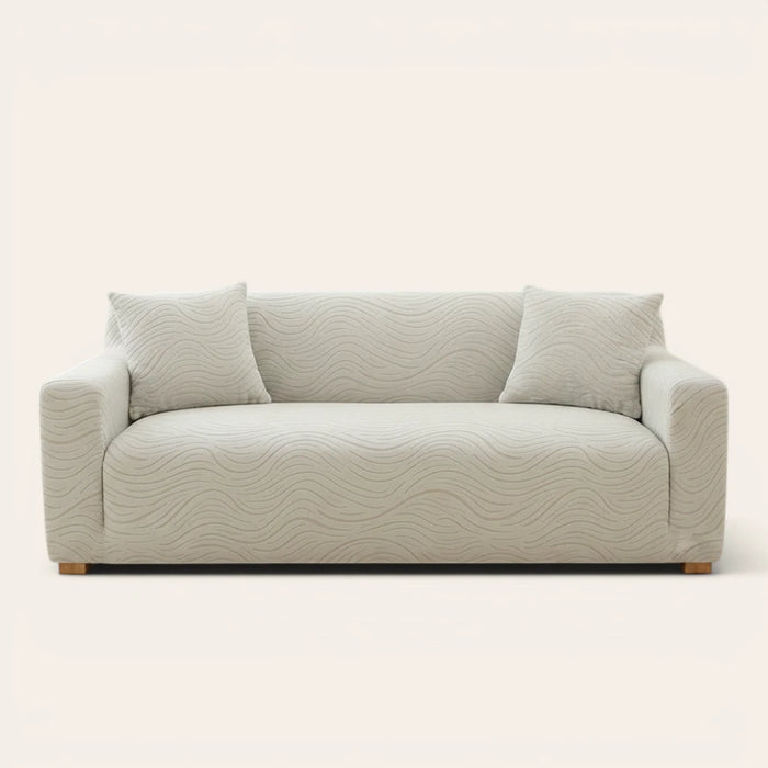 Soft ivory jacquard sofa cover fitted on a three-seater with wave pattern, front view on ivory backdrop