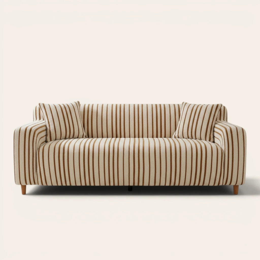 Caramel brown striped sofa cover on a three-seat sofa with matching cushions, front view on ivory