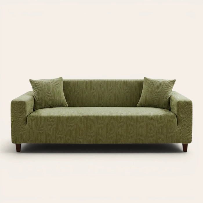 Sage green velvet sofa cover fitted on a three-seat sofa, front view on ivory backdrop