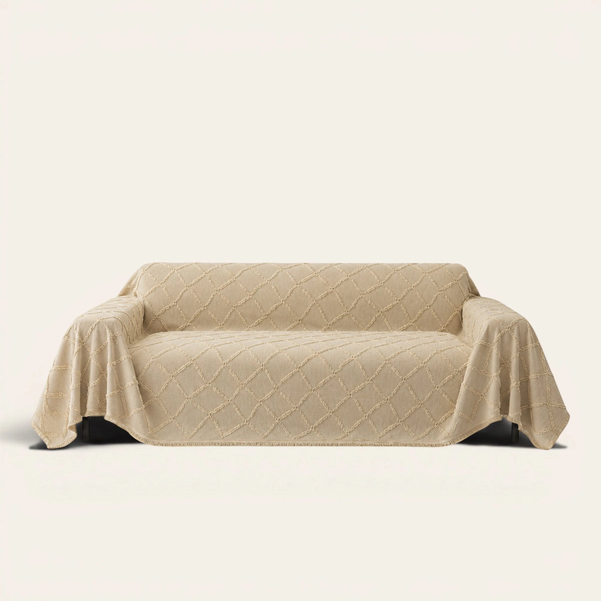 Luxe Diamond Oat Beige sofa throw draped over a three-seat sofa, front view on ivory