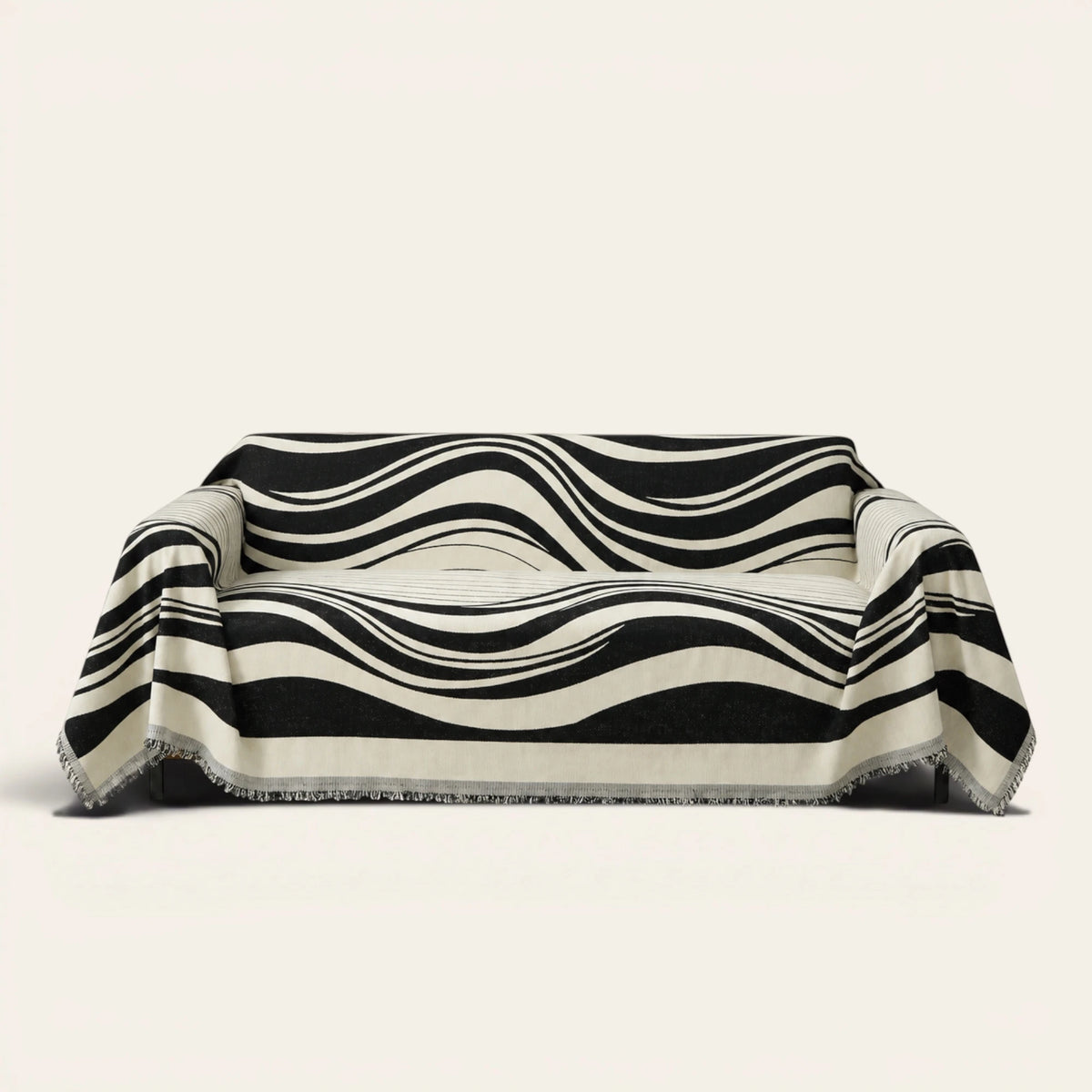 Modern Wave Monochrome Wave sofa throw draped over a three-seat sofa, front view on ivory