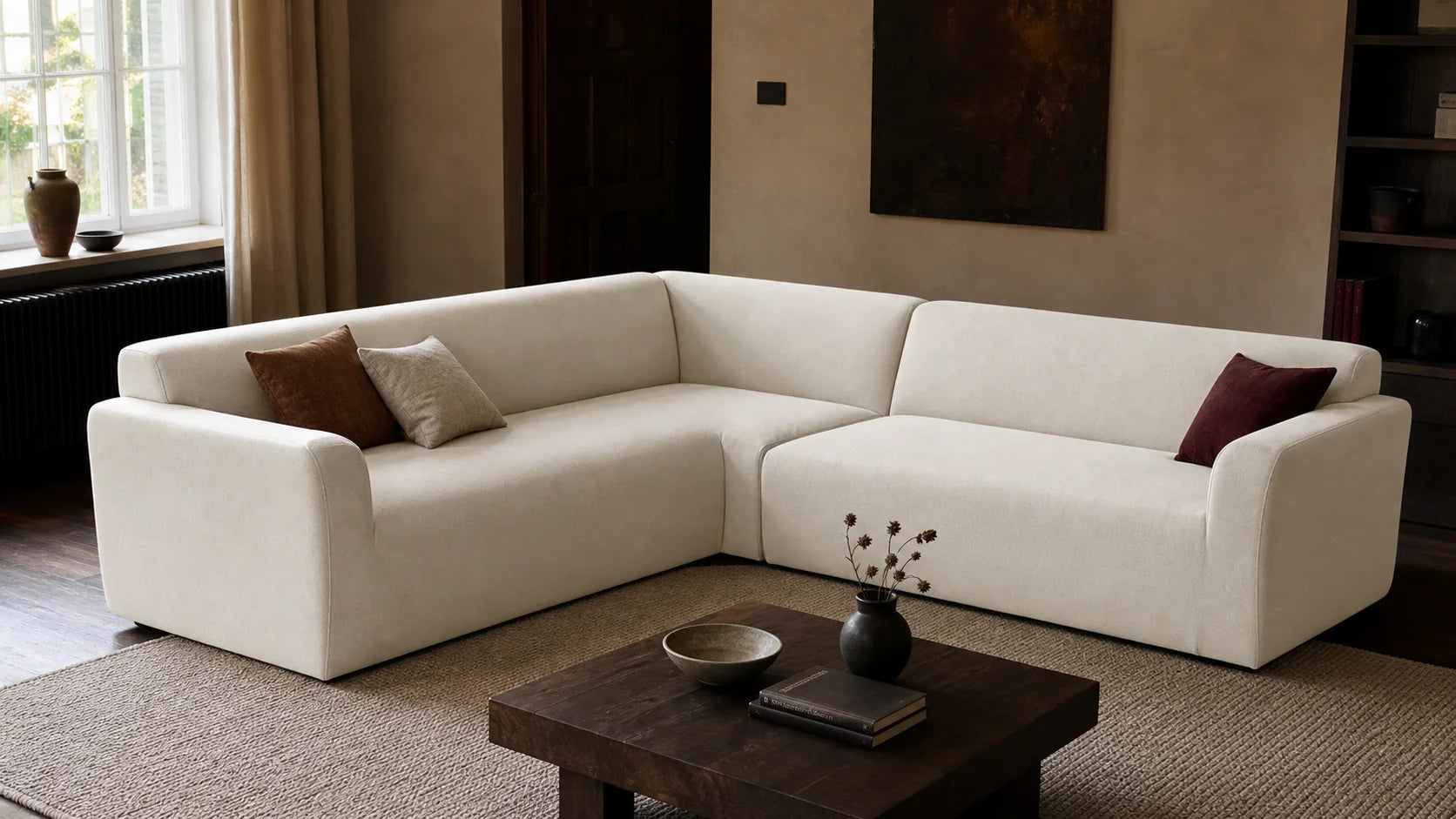 L-shape sofa formed from two sections in matching ivory stretch covers