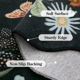 Covaba boho modern parisian floral scalloped rug in ink black, styled in a room setting