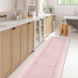 Covaba modern minimalist line runner rug in blush clay, styled in a room setting, view 2