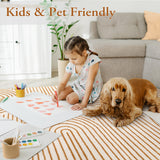 Covaba abstract rainbow stripe orange/white rug in amber clay, styled in a room setting, view 2