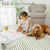 Covaba abstract rainbow stripe green/white rug in fern green, styled in a room setting, view 2