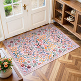 Covaba maximalism vibrant blossom floral doormat in blush clay, styled in a room setting