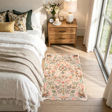 Covaba maximalist unicorn garden scalloped doormat in blush clay, styled in a room setting, view 3